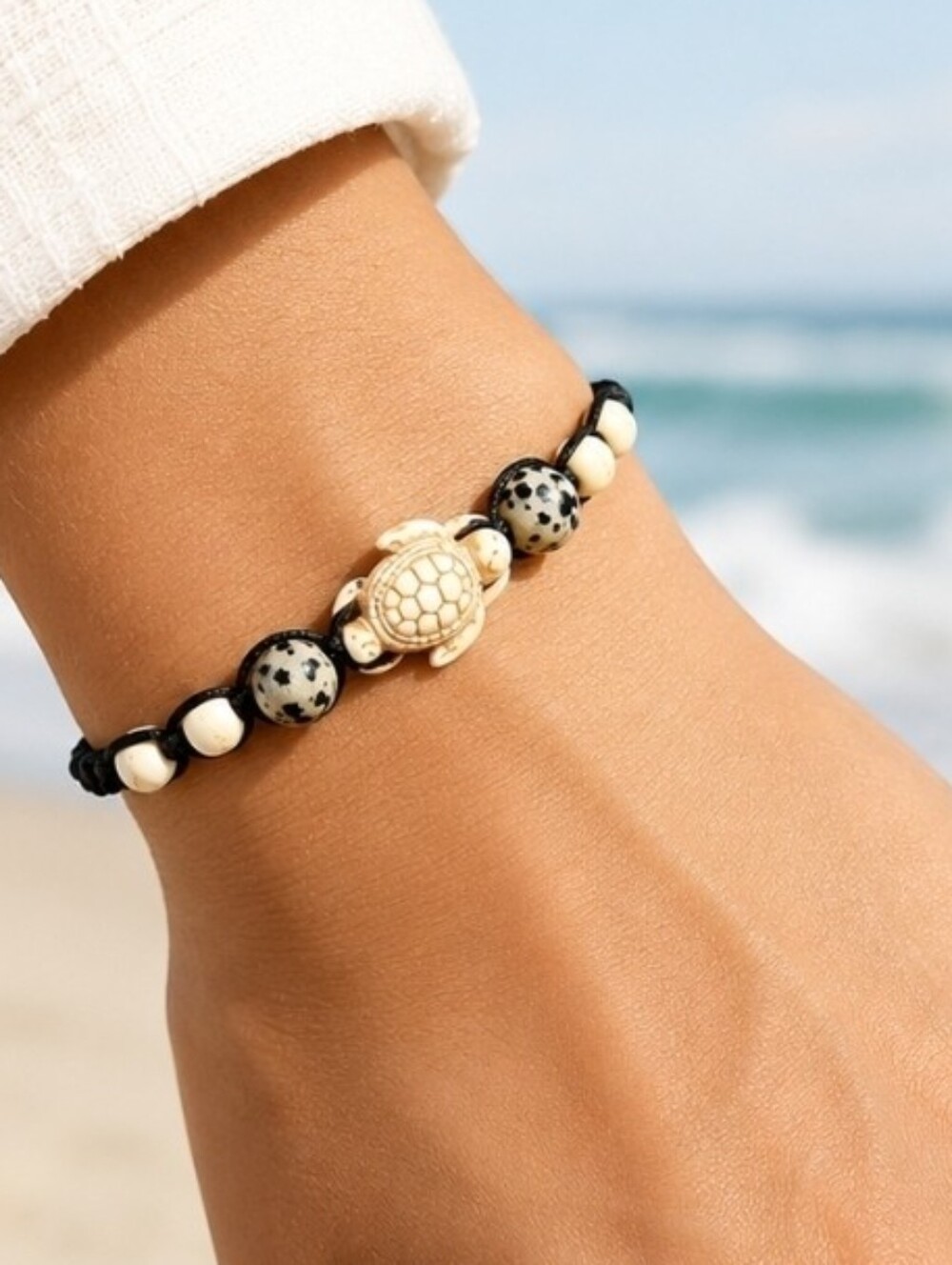 Ivory stone sea turtle, marbled beads and black adjustable corded bracelet New